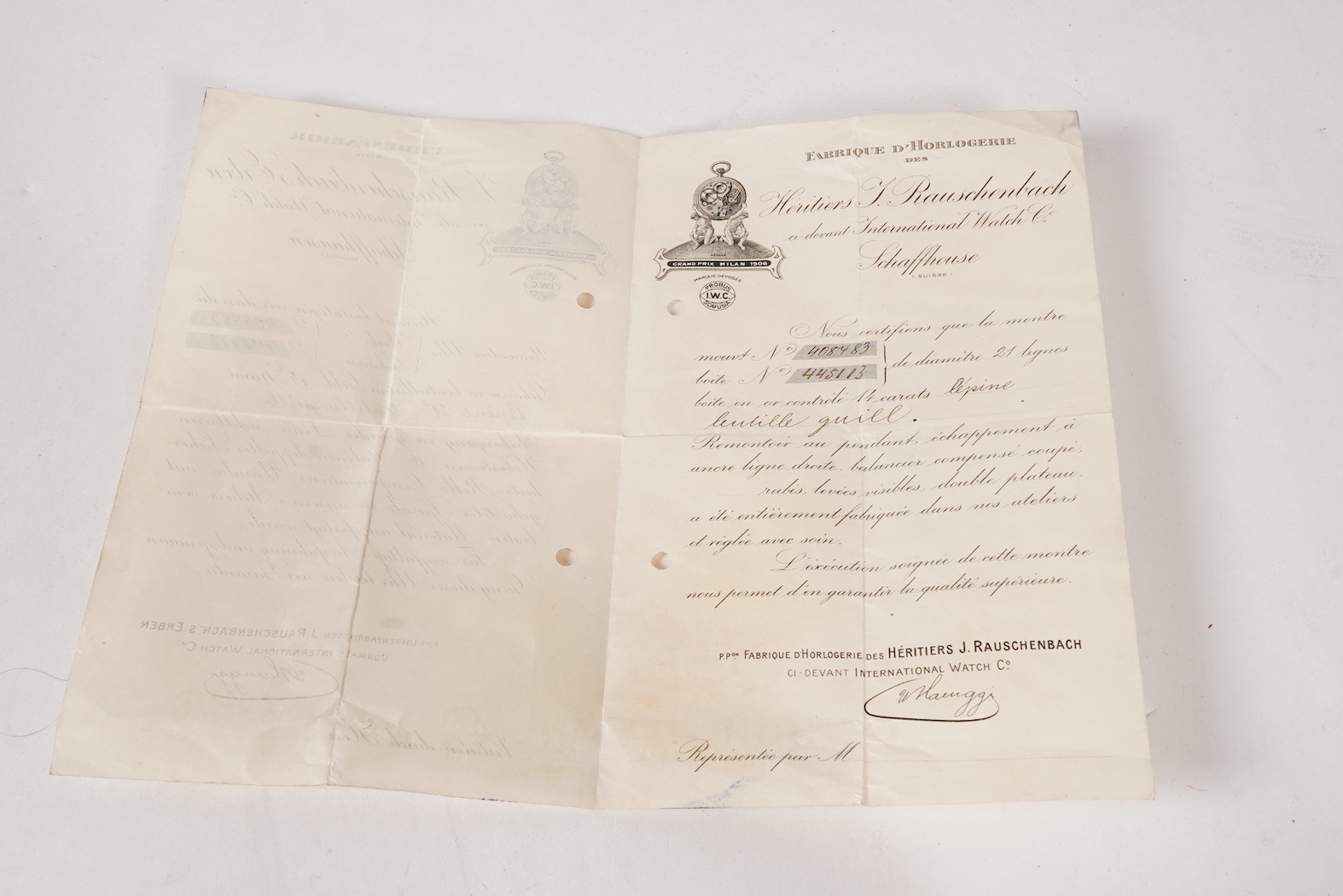 An early 20th century International Watch Company engine turned 14k yellow metal open faced keyless lever pocket watch, together with a Viennese? two colour yellow metal albert, maker's mark, LE